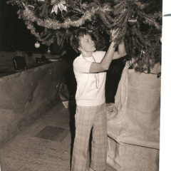 (FNB.2010.2.03) - Woman Decorating Christmas Tree in the Great Banking Hall, First National Center, c. 1974