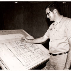 (FNB.2010.3.22) - First National Center Maintenance Man with Building Plans, c. 1970s
