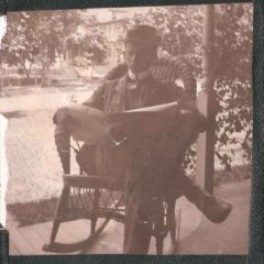 (HTC.2010.8.14) - Gentleman Reading Newspaper on Porch, c. 1890s