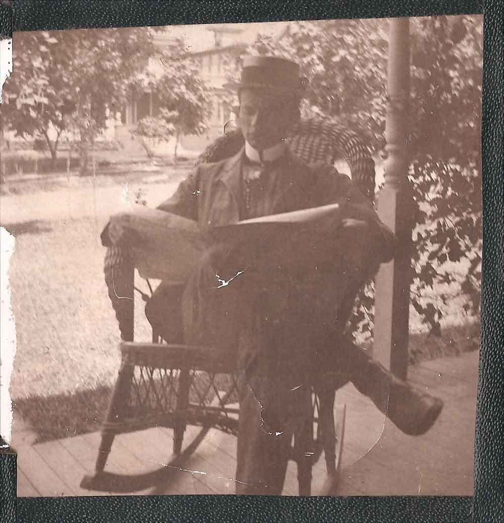 (HTC.2010.8.14) - Gentleman Reading Newspaper on Porch, c. 1890s