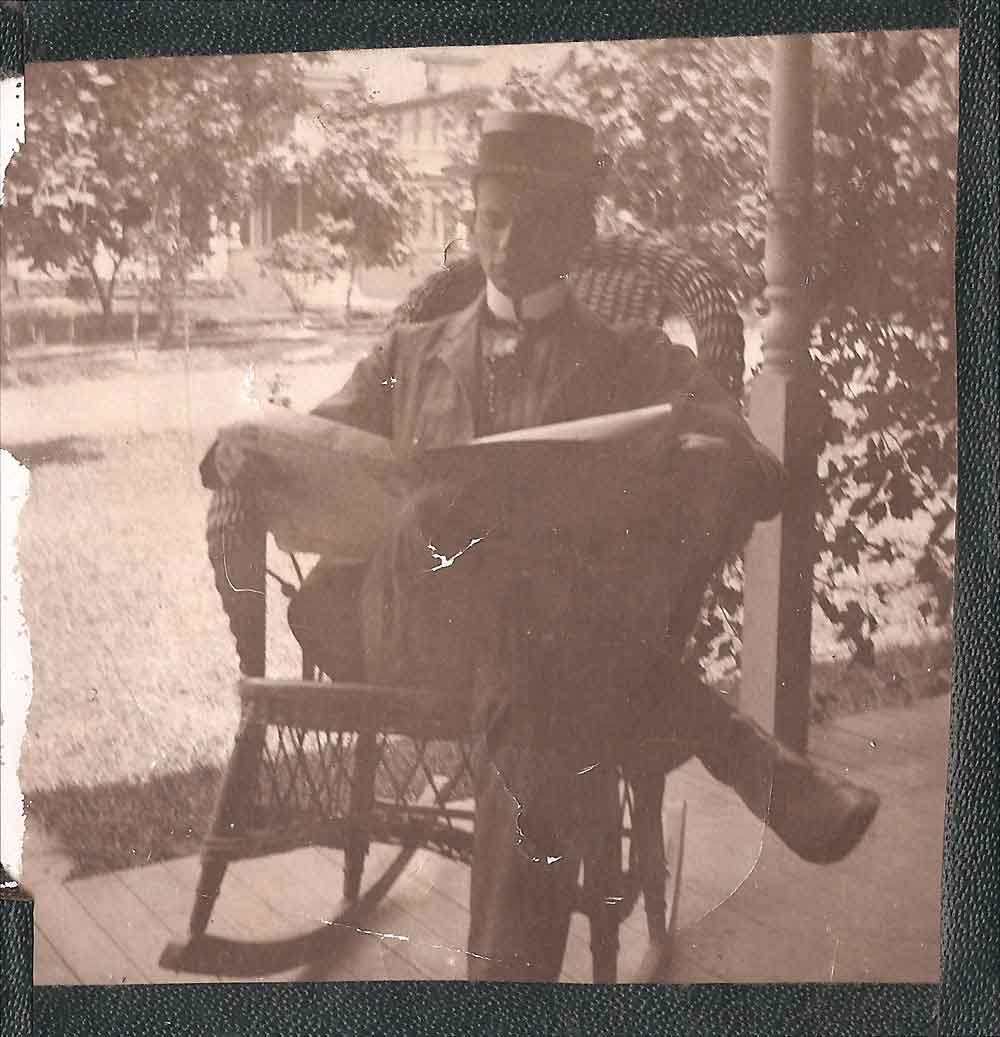 (HTC.2010.8.14) - Gentleman Reading Newspaper on Porch, c. 1890s