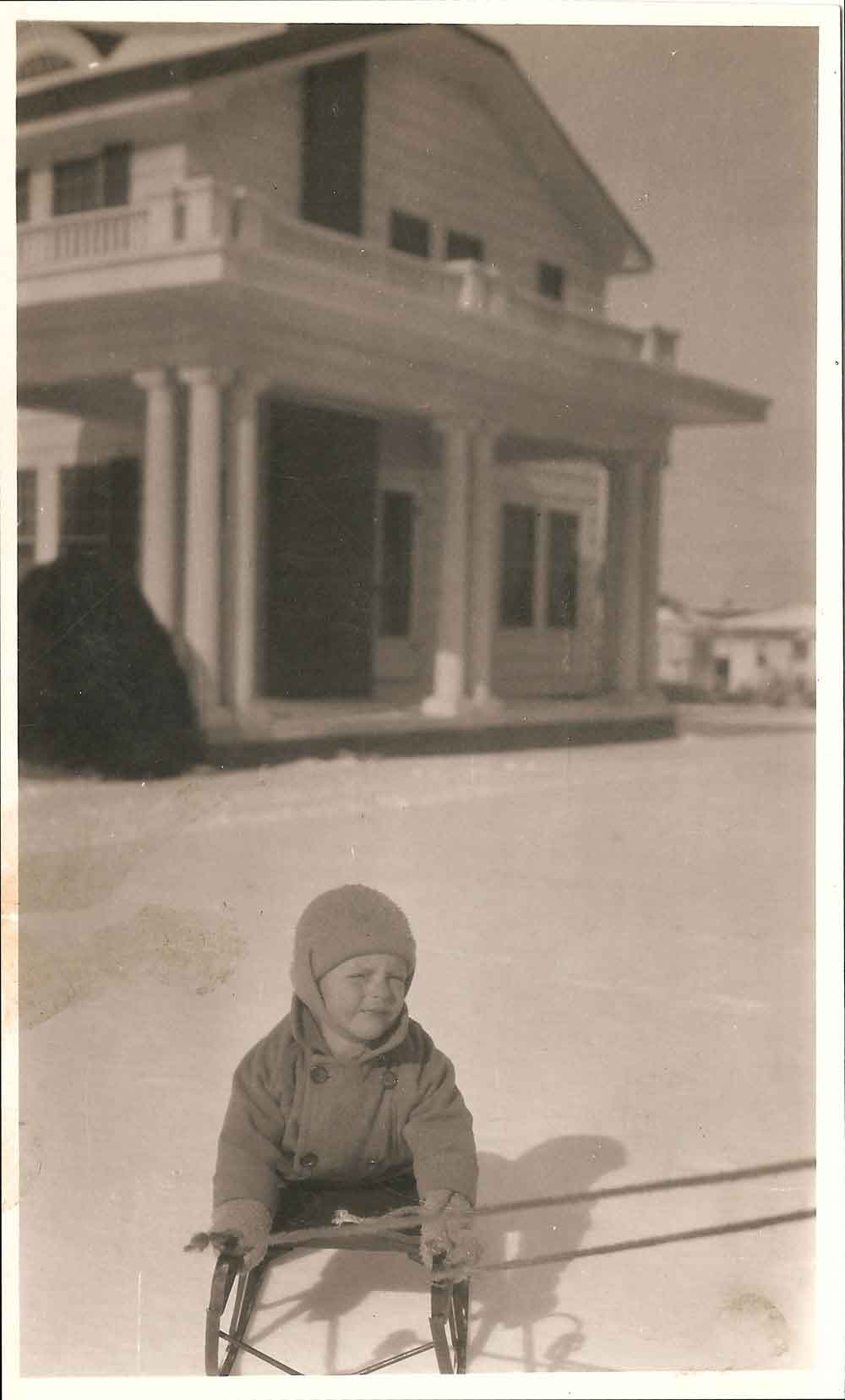 (HTC.2010.8.34) - Child (probably Frank Hightower) Sledding in Front of the Keene C. Burwell Home, 415 NW 21, c. 1926